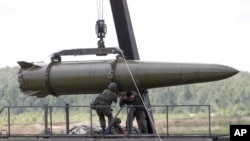 FILE - Russian servicemen equip an Iskander tactical missile system in Kubinka, outside Moscow, Russia, June 17, 2015. Russia has reportedly deployed the ground-launched SSC-8 cruise missile it has been developing and testing for several years.