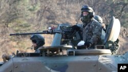 South Korean army soldiers ride an armored vehicle during an annual exercise in Paju, near the border with North Korea, South Korea, Dec. 2, 2016.