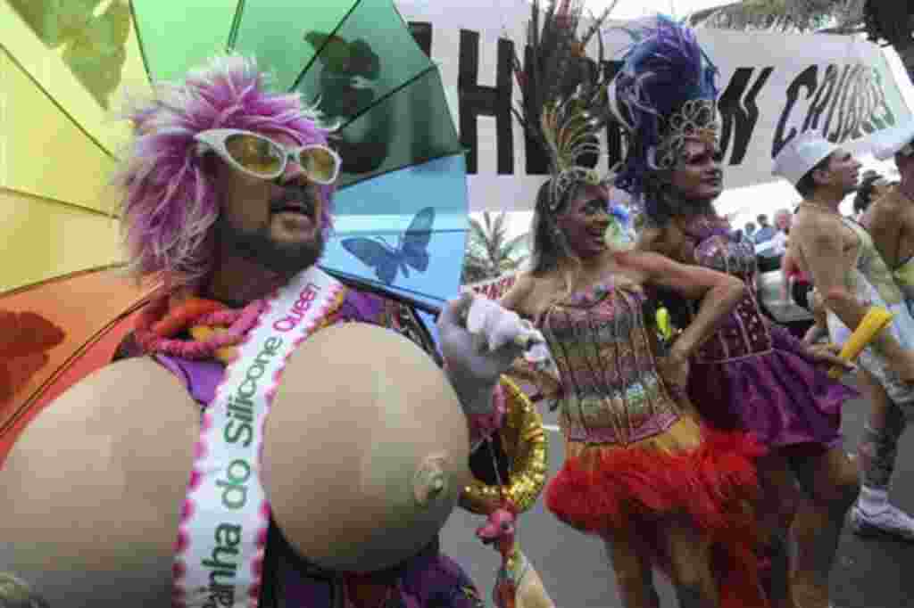 A reveler wearing a sash that reads in Portuguese "Queen of the Silicone", takes part at the Banda de Ipanema carnival parade in Rio de Janeiro, Brazil, Saturday, Feb. 19, 2011. Hundreds of people gathered Saturday during one of the many parades which tak
