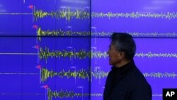 Yun Won-tae of the Korea Meteorological Administration stands in front of a screen showing seismic waves that were measured in Seoul after North Korea said it had conducted a powerful hydrogen bomb test, Dec. 6, 2015.