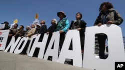 Protesters hold letters reading "NO THAAD" during a rally to oppose a plan to deploy an advanced U.S. missile defense system called Terminal High-Altitude Area Defense, or THAAD, near the U.S. Embassy in Seoul, South Korea, April 26, 2017. 