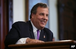 FILE - New Jersey Gov. Chris Christie laughs at a question from the media after speaking in Trenton, N.J.