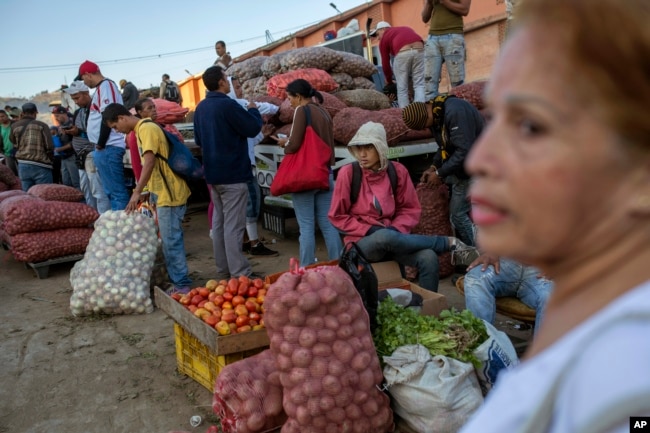 Vegetable vendors wait for customers at a wholesale food market in Caracas, Venezuela, Jan. 28, 2019.