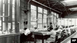 Young women at work in the US Radium factory in Orange, New Jersey in the mid-1920s. Many became ill and died after working with radioactive glow-in-the-dark paint.