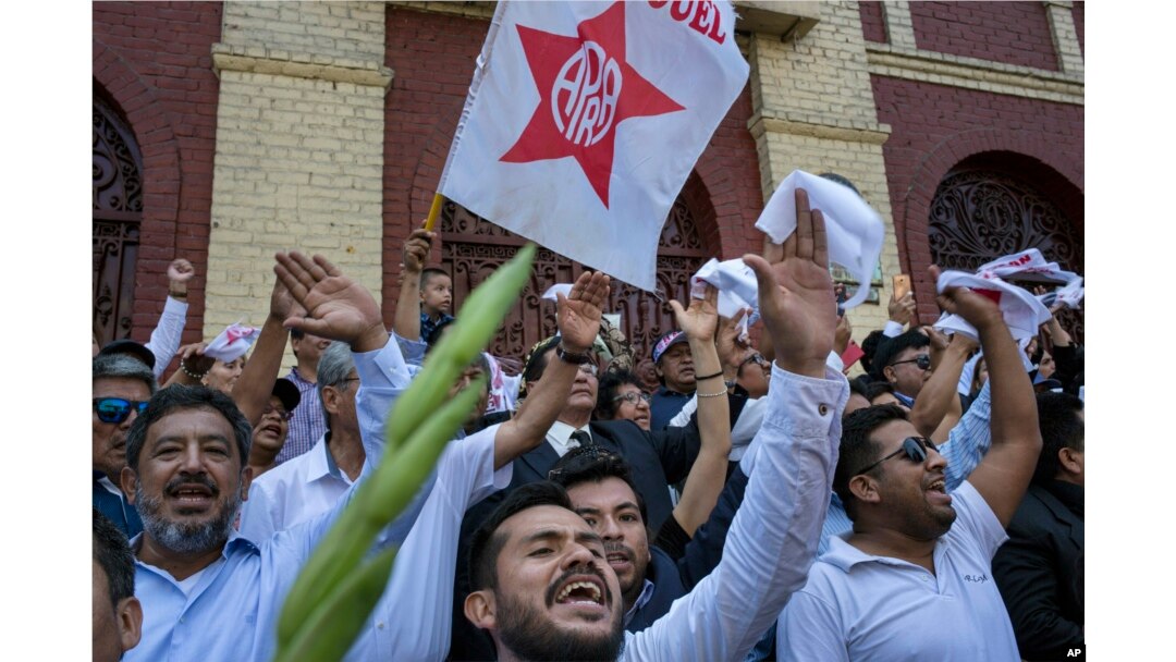 Supporters of Peru's late President Alan Garcia chant slogans during his funeral procession in Lima, Peru, April 19, 2019.