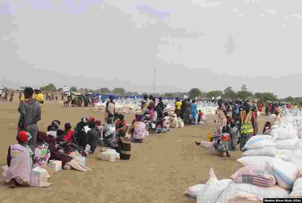 Displaced South Sudanese wait on Saturday, March 21, 2015, in Ganyiel, Unity state for sacks of food provided by the World Food Program (WFP) to be distributed. 