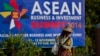 A sweeper cleans a road in the foreground of a billboard promoting Association of Southeast Asian Nations (ASEAN) summit in Naypyitaw, Myanmar, Tuesday, Nov 11, 2014. Myanmar hosts the ASEAN summit and related meetings on Nov. 12 and 13. (AP Photo)