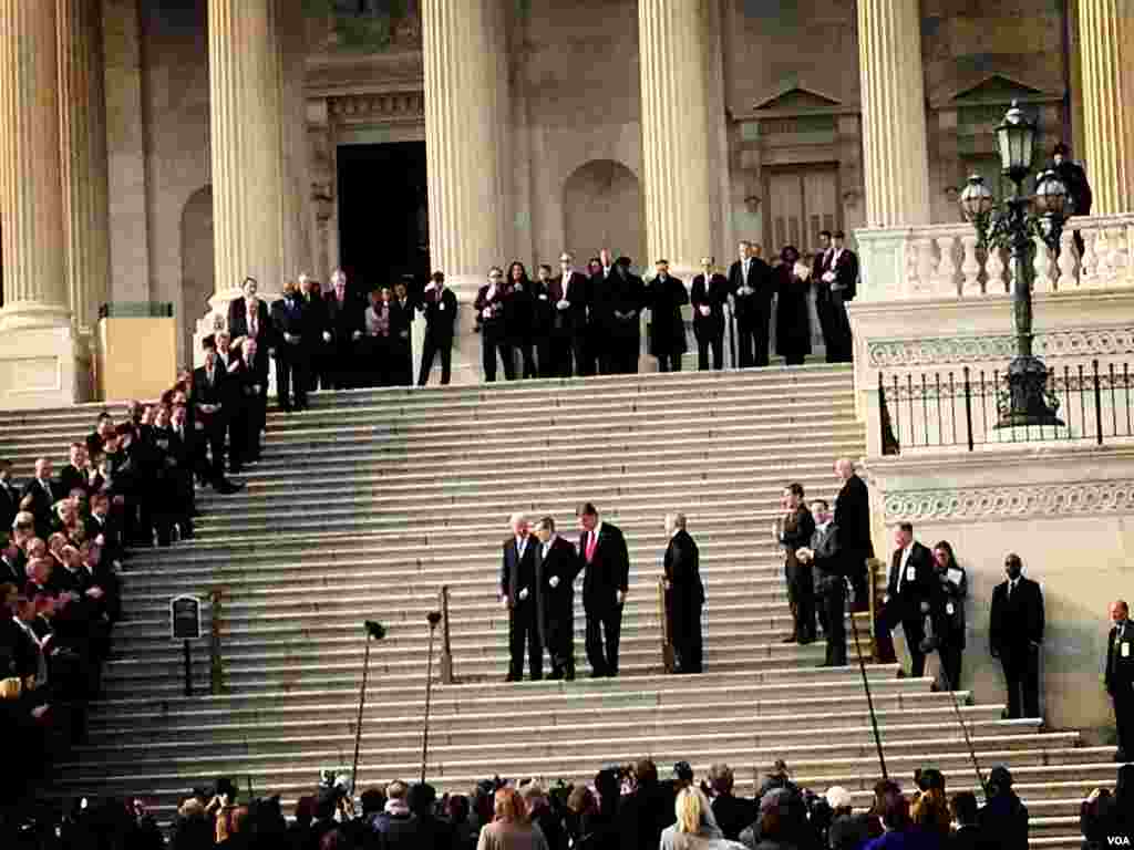 Senator Mark Kirk is applauded by members of the House and Senate as he stands with U.S. Vice President Joe Biden on his return to the U.S. Senate after suffering a stroke, January 3, 2013.