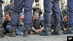 Reporters Without Borders activists are surrounded by riot policemen in front of the Ritz hotel in Paris, September 2011. (file photo)