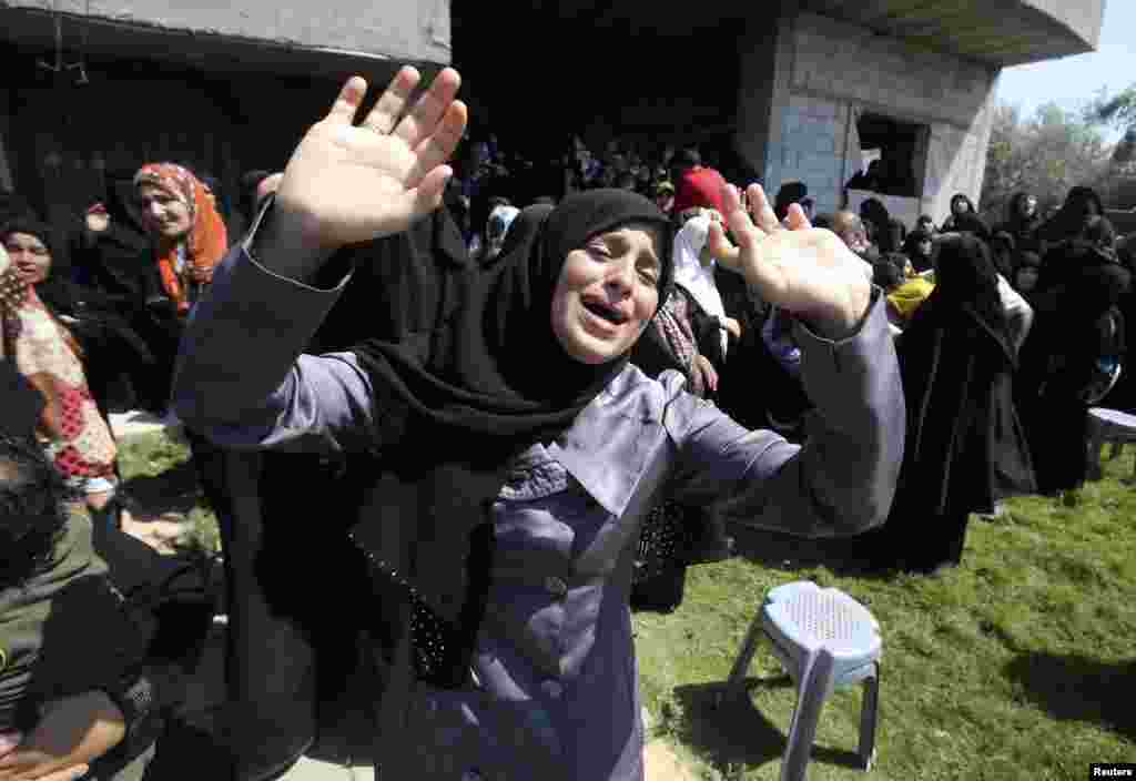 A relative of a Hamas militant mourns during his funeral in Rafah in the southern Gaza Strip, July 7, 2014. 