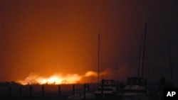 A fire burns dozens of homes in a flooded neighborhood in the borough of Queens, New York, Oct. 30, 2012.