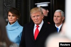 FILE - President Donald Trump and Melania Trump depart the 2017 Presidential Inauguration at the U.S. Capitol, Jan. 20, 2017. Vice President Mike Pence is at right.