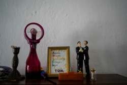Figurines representing grooms stand on display in the home of partners Lázaro “Lachi” González and Adiel González in Matanzas, Cuba, Thursday, Oct. 7, 2021. (AP Photo/Ramon Espinosa)
