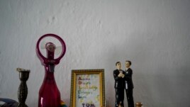 Figurines representing grooms stand on display in the home of partners Lázaro “Lachi” González and Adiel González in Matanzas, Cuba, Thursday, Oct. 7, 2021. (AP Photo/Ramon Espinosa)