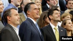 Mitt Romney, vice-presidential candidate Paul Ryan (R) and Campaign Manager Matt Rhoades pose for a staff portrait on the steps of the stage at the Republican National Convention, August 30, 2012.