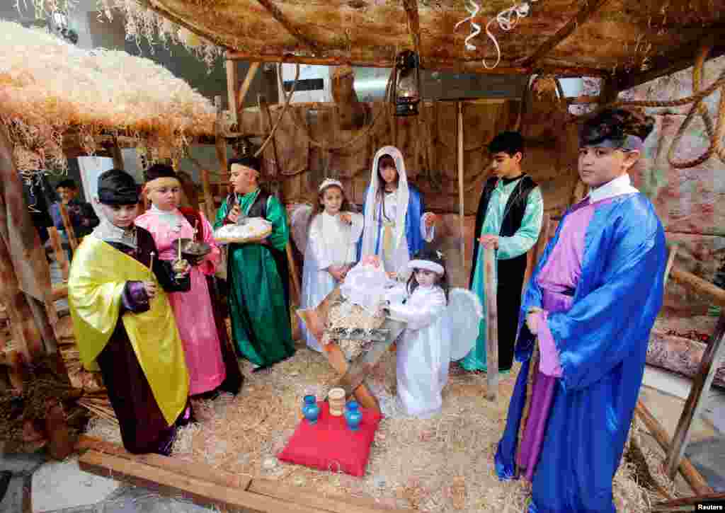 Children participate in a nativity scene at Mart Shmoni Church in the town of Bashiqa, east of Mosul, Iraq, Dec. 25, 2018.