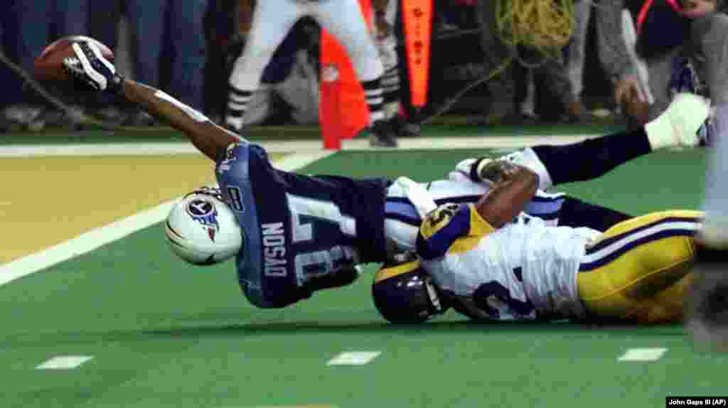 Tennessee Titans wide receiver Kevin Dyson (87) tries but fails to get the ball into the end zone as he is tackled by St. Louis Rams&#39; Mike Jones on the final play of Super Bowl XXXIV on Sunday, Jan. 30, 2000, in Atlanta. The Rams won 23-16. The year before, the Rams were one of the worst teams in the NFL.