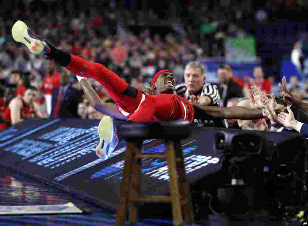 Texas Tech forward Tariq Owens lands on the scorers table while trying to save a ball from going out of bounds during the first half against Michigan State in the semifinals of the Final Four NCAA college basketball tournament, April 6, 2019, in in Minneapolis, Minnesota.