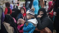 Displaced Syrians from the south of Idlib province queue to receive food aid from a truck in the countryside west of the town of Dana in the northwestern Syrian region on December 23, 2019. (Aaref Watad / AFP)