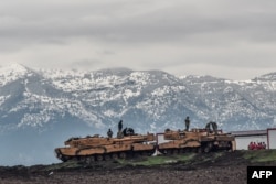 FILE - Turkish tanks are parked near the Syrian border at Hassa, in Hatay province, Jan. 24, 2018, as part of the "Operation Olive Branch."