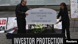 Demonstrators protest, waing investors that they too could become victims of a Wall Street fraud in New York May 8, 2012. Victims of the Beard Madoff investment fraud took part and helped organize the demonstration. REUTERS/Eduardo Munoz