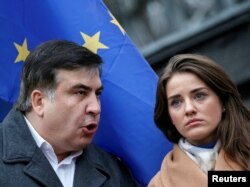 FILE - Former Georgian President and former governor of Odessa region Mikheil Saakashvili, left, and Yulia Marushevska, former head of the customs office at the Black Sea port of Odessa, attend an anti-government rally in central Kyiv, Ukraine, Nov. 27, 2016.