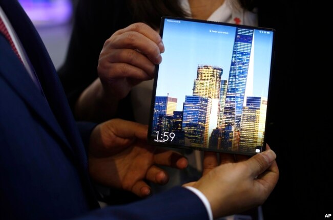 A man holds the new Huawei Mate X foldable 5G smartphone during the Mobile World Congress wireless show, in Barcelona, Spain, Feb. 26, 2019.