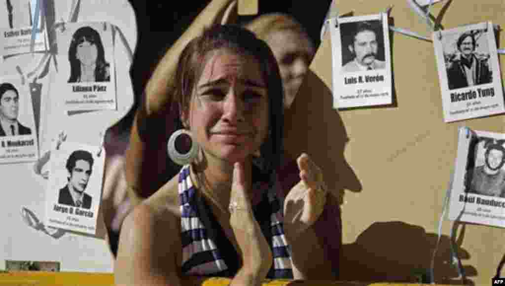 The relative of a victim killed during Argentina's dirty applauds as she listens to the sentence for former dictator Jorge Videla in Cordoba, Argentina, Wednesday Dec. 22, 2010. Videla was sentenced to life in prison Wednesday for the torture and murder