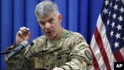 FILE - Col. Steve Warren, the new spokesman for the U.S.-led coalition in Iraq, speaks to reporters during a news conference at the U.S. Embassy in the heavily fortified Green Zone in Baghdad, Iraq.