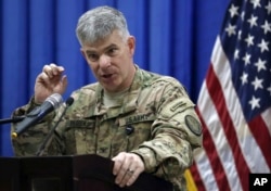 FILE - Col. Steve Warren speaks to reporters during a news conference at the U.S. Embassy in the heavily fortified Green Zone in Baghdad, Iraq.