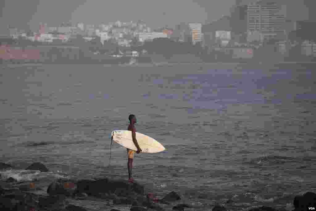 A surfer surveys the waves off Dakar, Senegal. (Annika Hammerschlag/VOA)