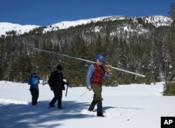 Frank Gehrke, chief of the California Cooperative Snow Surveys Program for the Department of Water Resources, checks the depth of the snowpack as he conducts the third manual snow survey of the season at Phillips Station near Echo Summit, California, Jan. 3, 2017.