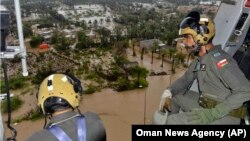 Oman Air Force personnel fly over the Al Khaburah district to assess damage from Cyclone Shaheen, Oct. 4, 2021.