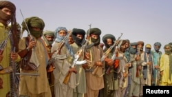FILE - Baluch rebels holding their weapons.
