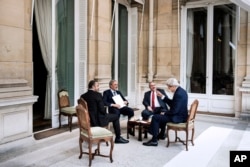 From left, Emirati Foreign Minister Sheikh Abdullah bin Zayed al-Nahyan, Saudi Arabia's Foreign Minister Prince Saud al-Faisal, Jordanian Foreign Minister Nasser Judeh and U.S. Secretary of State John Kerry discuss the crisis in Paris, France, June 26, 20
