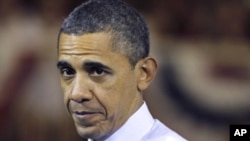 President Barack Obama pauses while speaking at Scranton High School in Scranton, Pa., Wednesday, Nov. 30, 2011.