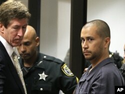 FILE - Attorney Mark O'Mara (L) looks on as George Zimmerman (R) makes his first appearance on second-degree murder charges in the shooting death of Trayvon Martin at the Seminole County Correctional Facility in Sanford, April 12, 2012. Zimmerman was found not guilty.