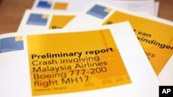 A stack of preliminary reports by the Dutch Safety Board on the crash of Malaysia Airlines flight MH17 is displayed at the board's headquarters in The Hague, Netherlands, Sept. 9, 2014.