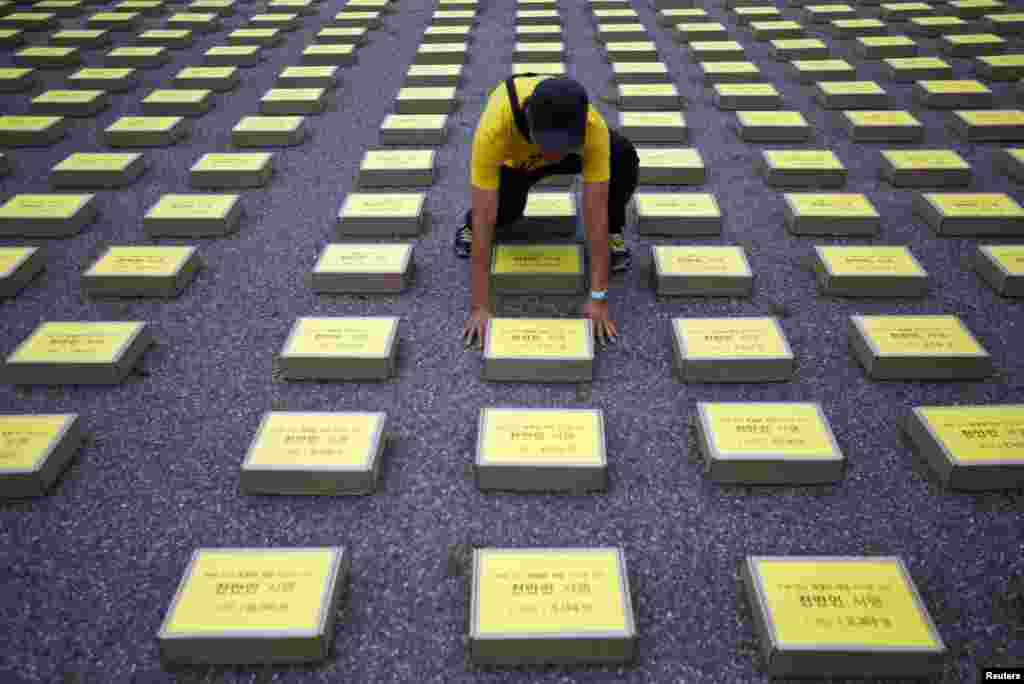 A man arranges a box containing signatures of South Koreans petitioning for the enactment of a special law after the mid-April Sewol ferry disaster, at Yeouido Park in Seoul. The petition is demanding the government for an impartial investigation into the disaster, as well as just punishment for those responsible and measures to prevent its recurrence, according to local media.