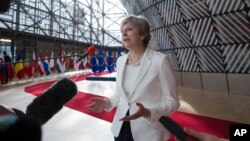 British Prime Minister Theresa May speaks with the media as she arrives for an EU summit at the Europa building in Brussels, June 23, 2017. European Union leaders meet in Brussels on the final day of their two-day summit to focus on ways to stop migrants crossing the Mediterranean and how to uphold free trade while preventing dumping on Europe's markets.