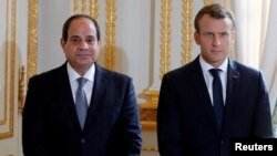 FILE - French President Emmanuel Macron and Egyptian President Abdel Fattah al-Sisi attend a news conference at the Elysee Palace, in Paris, Oct. 24, 2017. 
