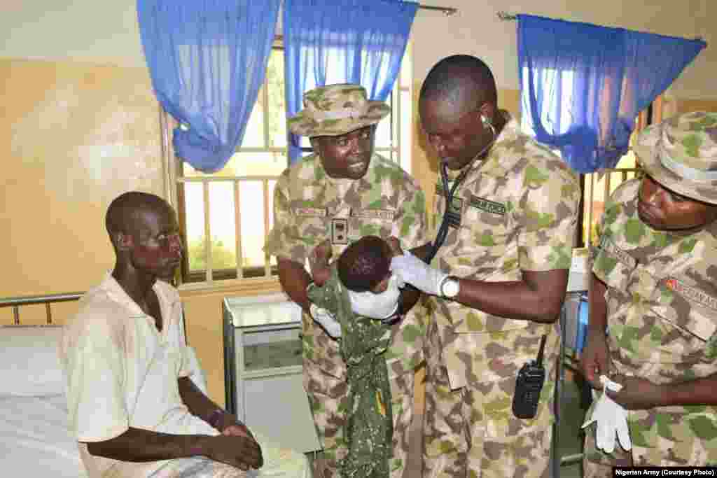 Nigerian military medical personnel examine Amina Ali's baby in Maiduguri.