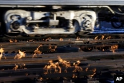 A Metra train moves southbound to downtown Chicago as the gas-fired switch heater on the rails keeps the ice and snow off the switches near Metra Western Avenue station in Chicago, Jan. 29, 2019.