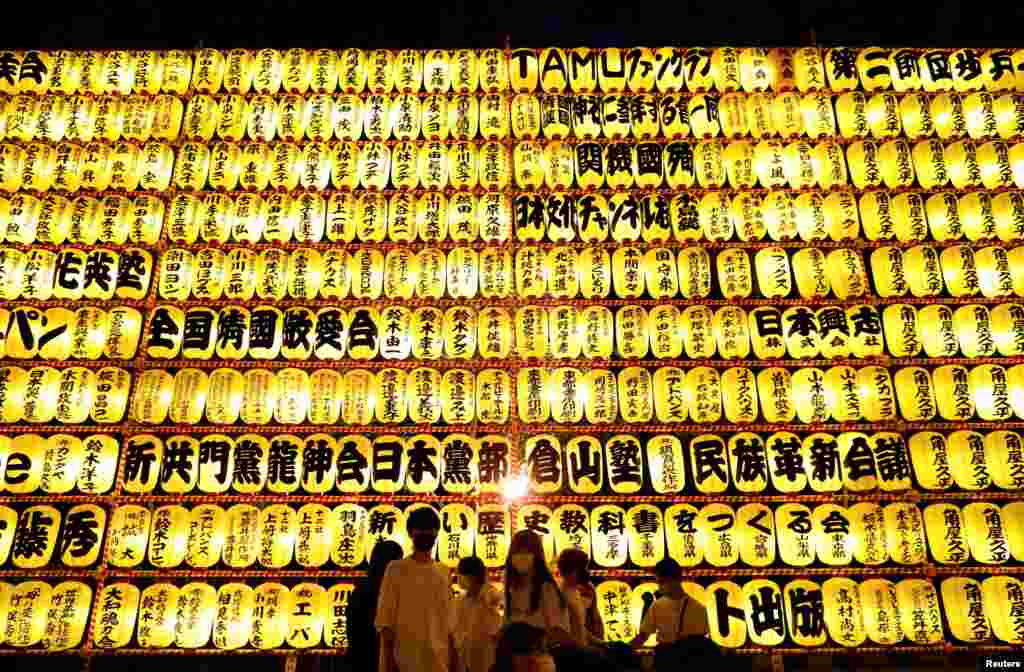 Visitors look at thousands paper lanterns during the Mitama Festival at the Yasukuni Shrine, where more than 2.4 million war-dead are enshrined in Tokyo, Japan.