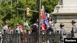 The Confederate battle flag is permanently removed from the South Carolina statehouse grounds during a ceremony in Columbia, July, 10, 2015. 