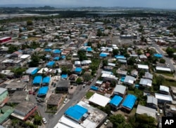FILE - This June 18, 2018 photo shows an aerial view of the Amelia neighborhood in the municipality of Catano, east of San Juan, Puerto Rico.