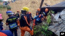 Rescuers conduct search houses for survivors after a landslide struck a village in Naga city, Cebu province central Philippines on Thursday Sept. 20, 2018. (AP Photo)