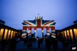 The Brandenburg Gate is illuminated with the British national flag to pay tribute to the victims of an attack in London, at the German capital in Berlin, March 23, 2017.