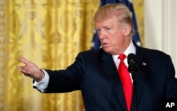 FILE - President Donald Trump gestures during a news conference in the East Room of the White House, Aug. 28, 2017.