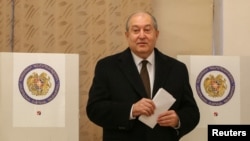 FILE - Armenian President Armen Sarkissian votes during an early parliamentary election in Yerevan, Dec. 9, 2018.